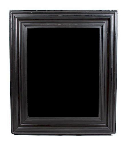 * An Ebony Framed Mirror Height 47 x width 41 inches.