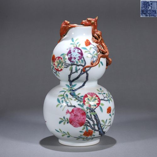 A famille rose pomegranate porcelain gourd shaped vase
