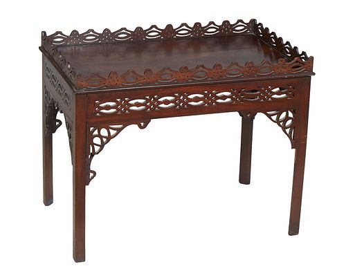English Carved Mahogany Chippendale Style Coffee Table, 20th c., with a pierced gallery on all sides, over a pierced skirt, on square legs with pierce