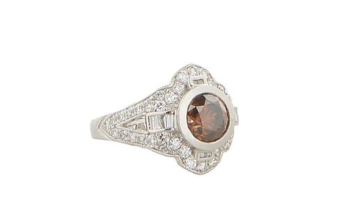 Lady's Platinum Dinner Ring, with a round 1.82 carat fancy brown diamond atop a diamond mounted border flanked by diamond baguette mounted legs, the s