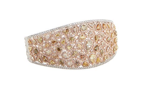 Lady's 14K White and Rose Gold Hinged Bangle Bracelet, mounted with fancy yellow, pink and brown pear shaped diamonds, within borders of tiny round wh