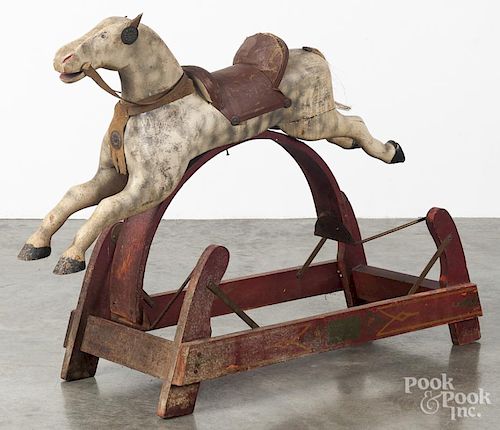 Child's painted wood hobby horse, ca. 1900, with a red swing base, overall - 34'' l.