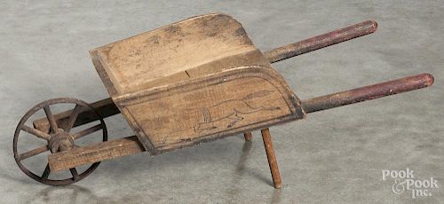 Child's wooden wheelbarrow, ca. 1900, with a stenciled running horse, 9'' h., 27'' l.