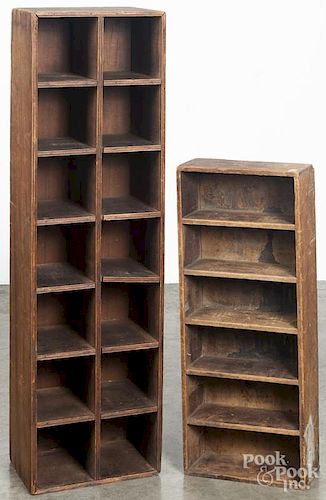 Two primitive pine hanging cubby hole cabinets, 19th c., 46'' h., 13'' w. and 31'' h., 12 1/2'' w.