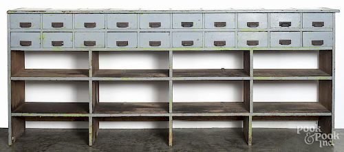 Large painted country store counter, ca. 1900, with two rows of ten drawers, over shelves