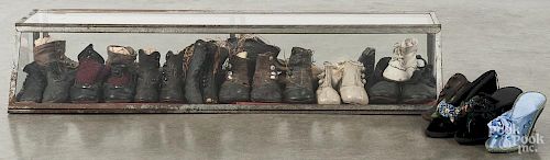 Country store counter top showcase, ca. 1900, filled with ten pairs of children's shoes