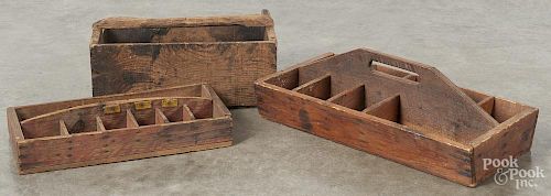Three primitive pine divided carriers, ca. 1900, 20 1/4'' w., 16 1/2'' w., and 15 1/2'' w.