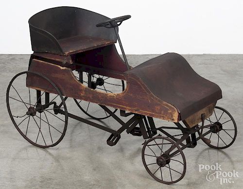 Early painted wood and tin pedal car, early 20th c., with remnants of the original red surface