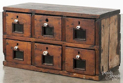 Primitive pine country store drawered cabinet, 19th c., having two rows of three drawers
