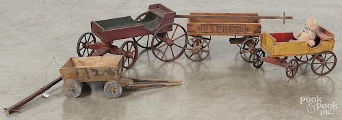 Four painted wood child's pull wagons, one retaining a red surface, 14'' l., one stenciled Express