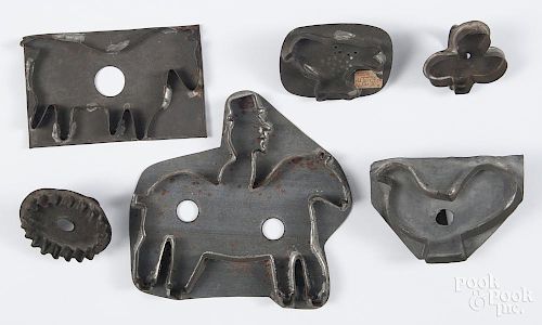 Six tin cookie cutters, 19th/20th c., largest is a man on a horse, 8 1/4'' w.