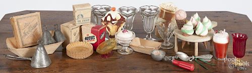 Ice cream related items, 20th c., to include an ice cream cone stand, advertising containers