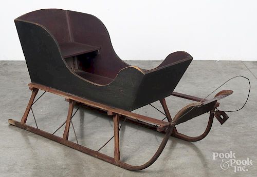 Child's painted pine pull sled, late 19th c., retaining an old red and black surface, 24'' h., 47'' l.