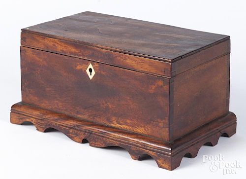 Figured mahogany dresser box, early 19th c., with a scalloped apron, 6'' h., 11'' w.