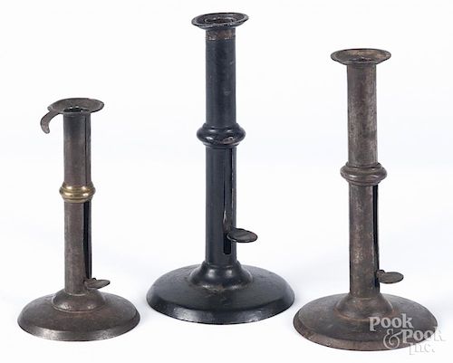 Three tin hogscraper candlesticks, 19th c., with wedding bands, one stamped Shaw, tallest - 9 1/2''