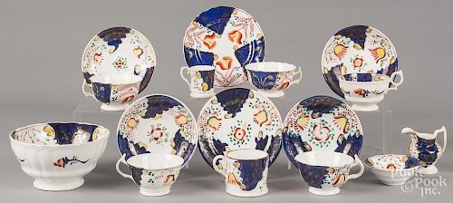 Sixteen pieces of Gaudy Welsh in the Tulip pattern, to include seven teacups, six saucers, a creamer