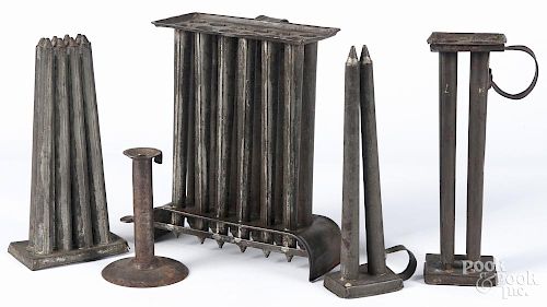 Four tin candlemolds, 19th c., together with a tin hogscraper candlestick, tallest - 11''.