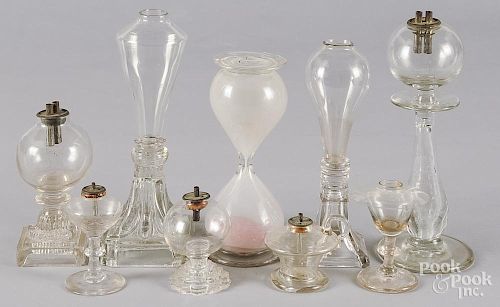 Eight colorless glass fluid lamps, 19th c., tallest - 9 1/4'', together with a sand timer, 7 3/4'' h.