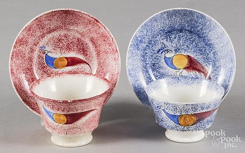Two spatter peafowl cups and saucers, 19th c., one red and one blue.