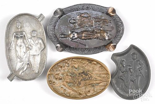 Four metal naughty ashtrays, early 20th c., to include cast brass, spelter, aluminum, and pewter
