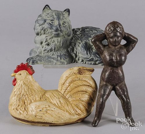 Cast iron hen doorstop, early 20th c., 5 1/2'' h., together with a cast iron Naughty Nellie bootjack