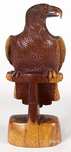 Carved mahogany eagle, 20th c., resting on a perch, 25'' h.
