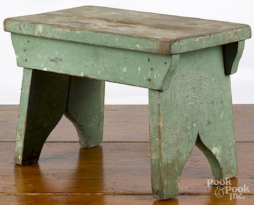 Primitive painted pine footstool, ca. 1900, retaining an apple green surface, 10 1/4'' h., 15'' w.