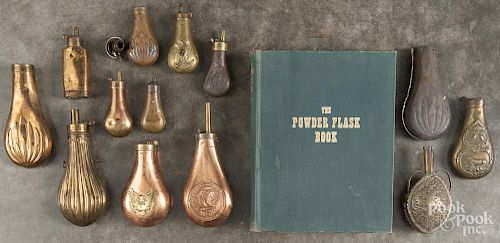 Twelve brass and copper powder flasks, 19th/20th c., tallest - 8''.