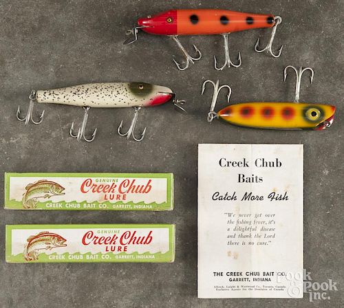 Two Creek Chub glass eyes pikie wood fishing lures, to include one in orange and red