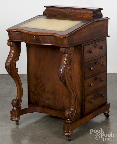 Regency rosewood davenport desk, 19th c., with carved cabriole front legs, 33'' h., 23 3/4'' w.