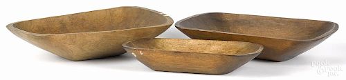 Three wooden trenchers, largest - 22 1/2'' h., 14'' w.