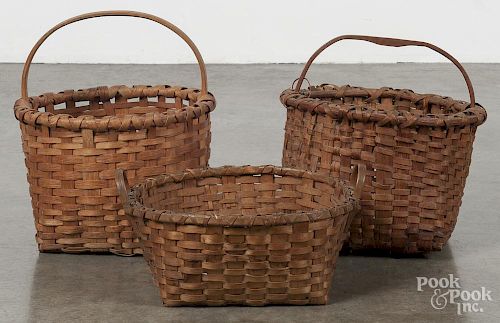 Three split oak baskets, largest - 13 1/2'' h., 12'' w.