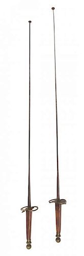 A Pair of Mahogany Handled Fencing Foils Length 39 1/2 inches.