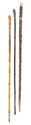 Three Rootwood Sword Canes Length of longest 36 1/8 inches.