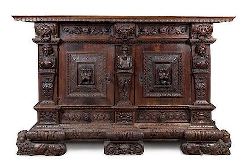 * A German Relief Carved Oak Cabinet Height 55 3/4 x width 86 1/2 x depth 27 1/4 inches.
