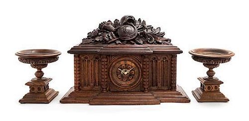 A Black Forest Style Carved Wood Clock Garniture Height overall 15 inches.