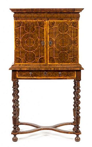 A William & Mary Oysterwood Cabinet on Stand Height 54 1/2 x width 29 1/2 x depth 18 1/4 inches.