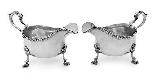 * A Pair of George III Silver Sauce Boats, Thomas Heming, London, 1774, each having a gadrooned rim and a leaf-capped handle, ra