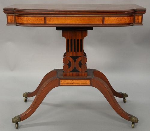 Federal mahogany games table having D shaped top over conforming frieze set on ebony inlaid column style supports on base with four ...
