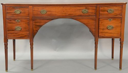 Mahogany Sheraton sideboard with rectangular top over three drawers over deep drawer and one door all set on turned legs. ht. 40 1/2...