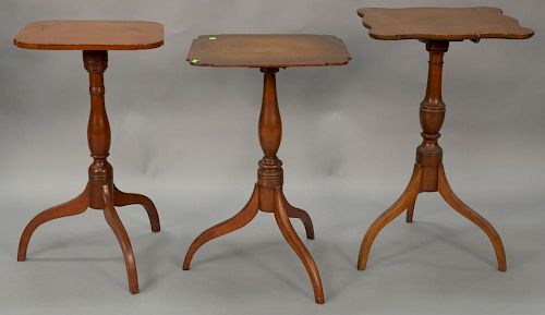 Three Federal cherry candlestands with shaped tops. ht. 27in., 28 1/2in., & 29 1/2in.