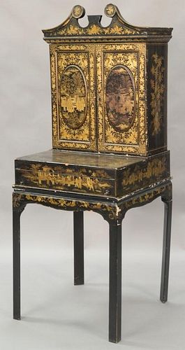 Chinese lacquered secretary in three parts, top molding over upper portion with large finial and two doors over desk with hinged wri...