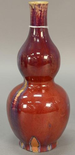 Chinese flambe glazed porcelain double gourd vase, oxblood red suffused with purple and light blue streaks. ht. 10in.