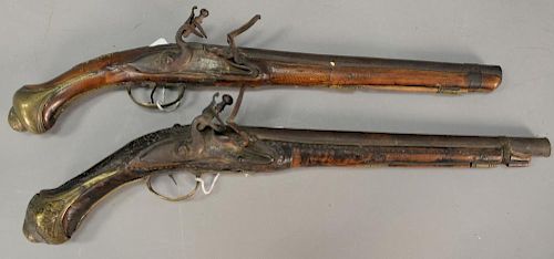 Two flintlock pistols with inset brass plaques and carved wood stock. lg. 19in. & 20in.