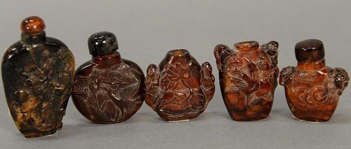 Five small amber snuff bottles carved with monkeys, dragons, mice, and frogs.  ht. 1 1/2in. to 2 1/4in.