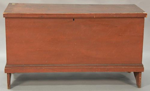 Primitive lift top blanket chest with molded lid and molded trim set on bootjack ends, retaining original red finish, 18th century. ...