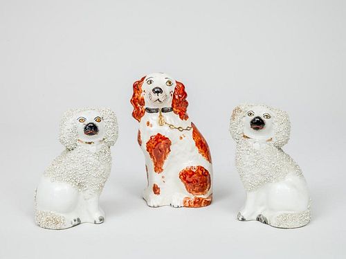 Pair of Staffordshire Pottery Poodles and a Staffordshire Pottery Red and White Spaniel
