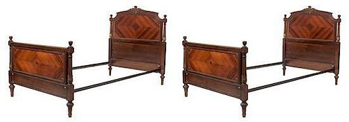 A Pair of Louis XVI Style Bookmatch Veneered Beds Height 48 x width 42 1/2 x depth 81 inches.