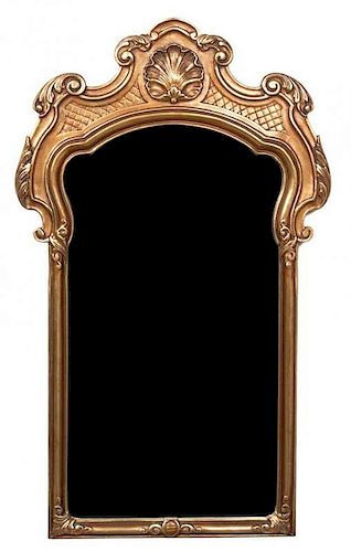 A Rococo Style Giltwood Mirror Height 43 1/2 x width 25 1/2 inches.