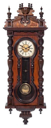 A Victorian Walnut Regulator Clock Height 44 1/4 x width 18 1/2 inches.
